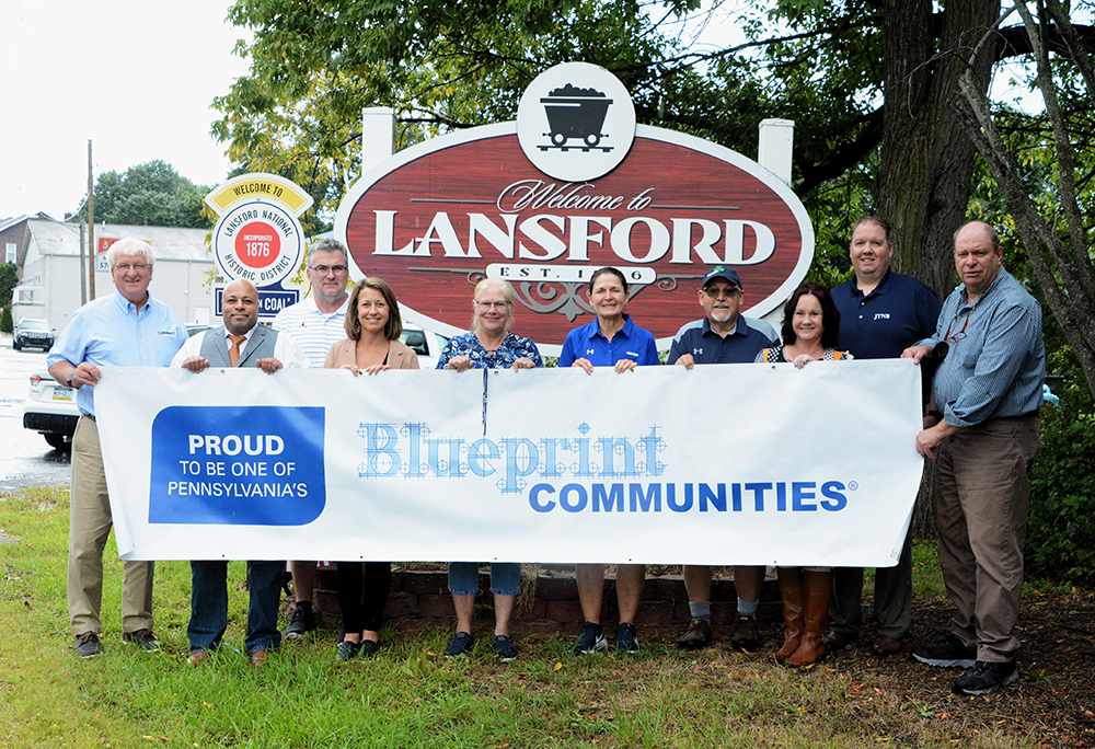 Lansford Group holding Blueprint Communities banner