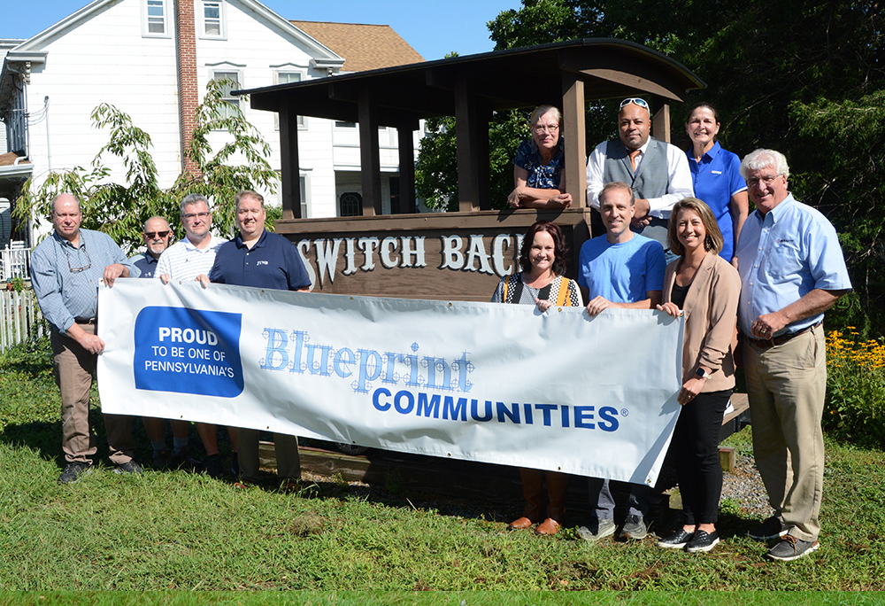 Summit Hill Group holding Blueprint Communities banner