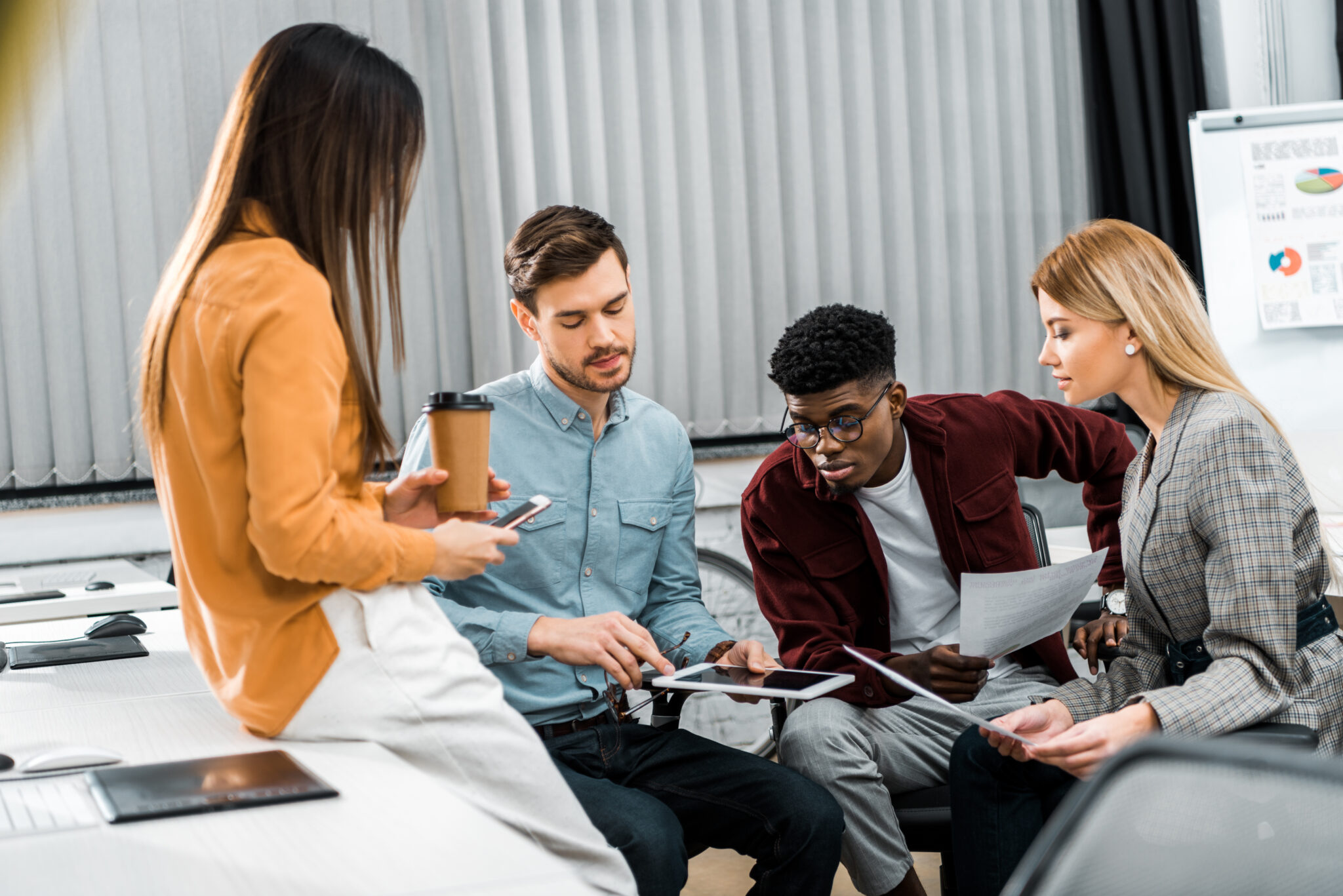 multicultural young businesspeople discussing new business idea in office