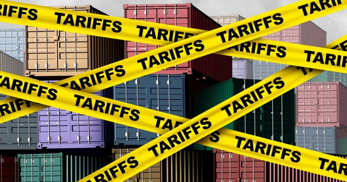 33 Shipping containers obscured by yellow tape with the word "TARIFFS."