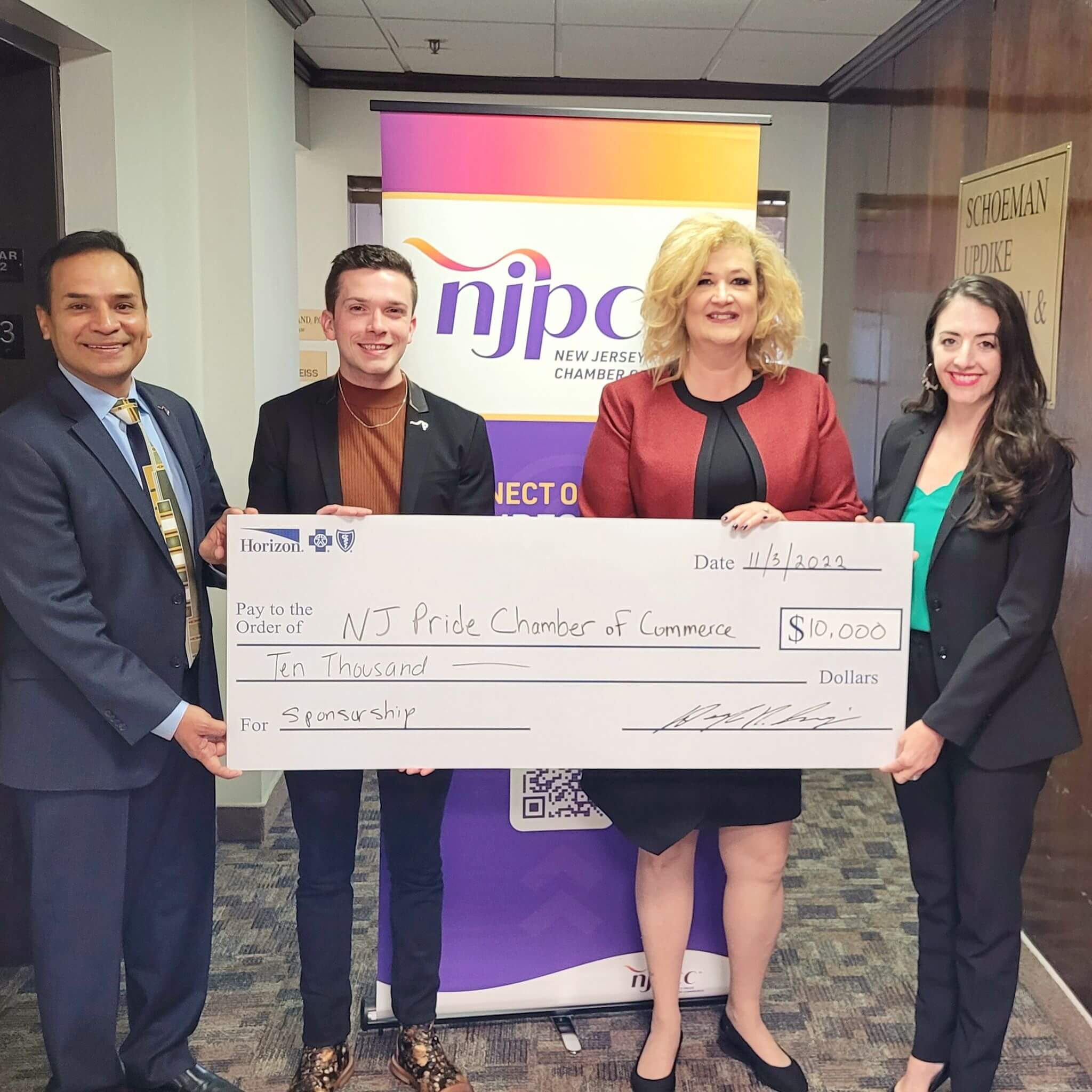 Horizon Blue Cross Blue Shield of New Jersey presents a check to New Jersey Pride Chamber of Commerce leadership (Gus Penaranda and Stephen Blazejewski).