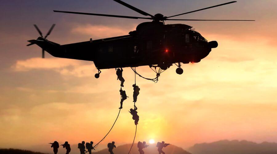 soldiers dropping from a helicopter