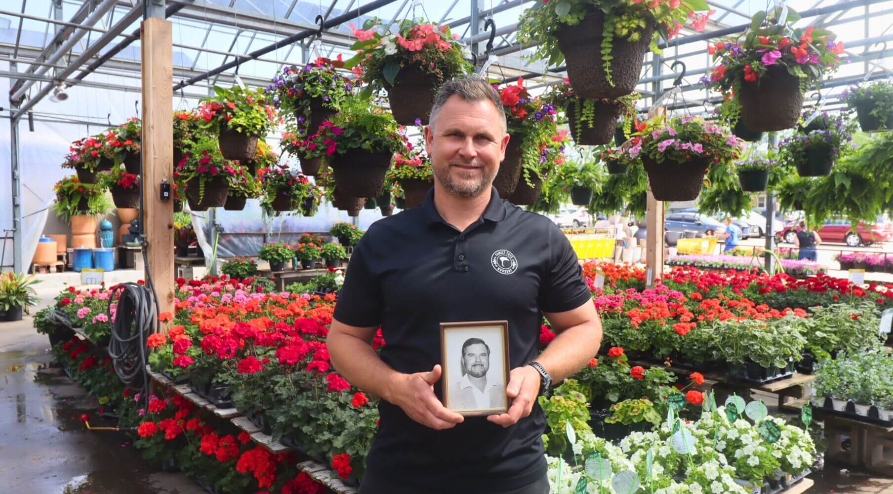 Jesse Nelson holding a photo of his grandfather, Ron Nelson.