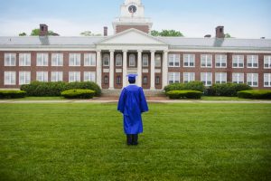 College Graduate Looking At College Building --- Image by © Randy Faris/Corbis