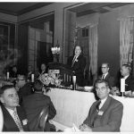 Herman Henkle is addressing participants at the luncheon honoring FID delegates. Speakers' table, l to r: K. Heumann (ADI president), Alexander King (FID president), Dr. L. Quicy Mumford, Library of Congress, D. Fink
