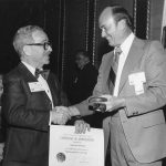 Si Newman receives Certificate of Appreciation from President John Sherrod