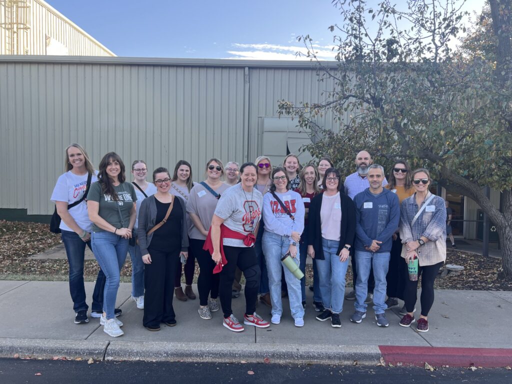 Group of teachers standing outside a building