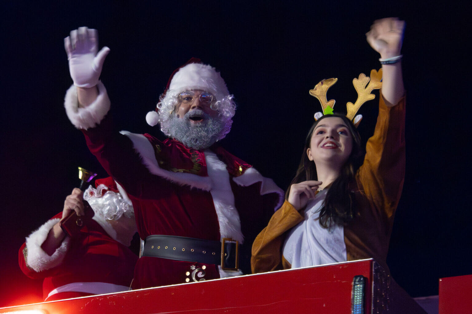 Santa and a reindeer wave from firetruck at the Standstill Parade of Lights