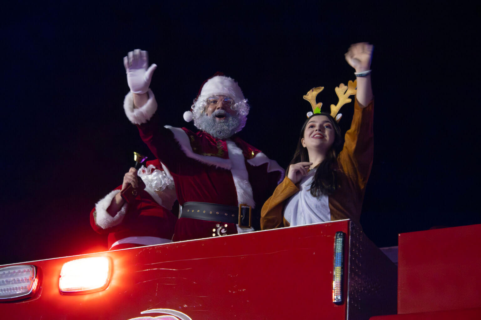 Santa and reindeer waving at parade
