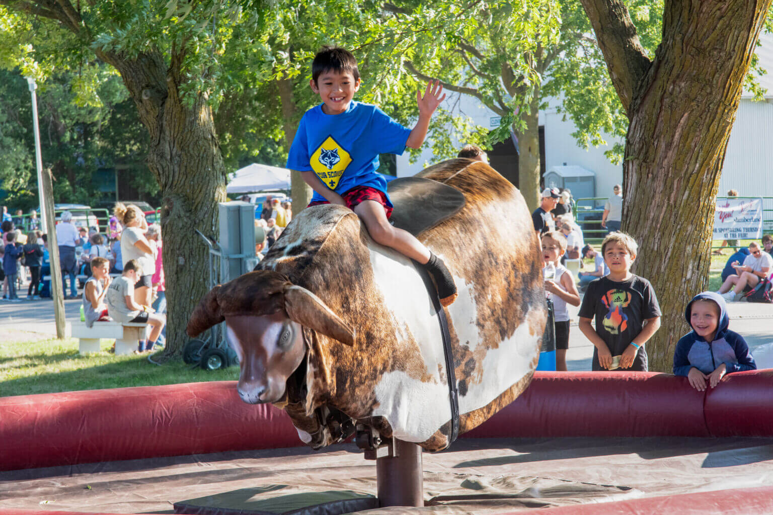 A boy rides an electronic bull at the Clay County Fair