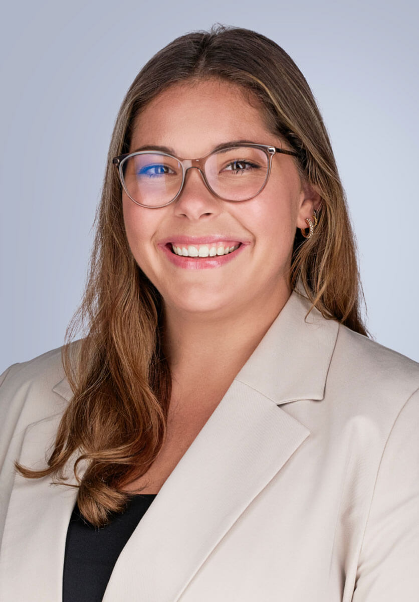 Hanna DeLange Hanna DeLange's headshot. She is wearing a cream blazer and glasses and is smiling at the camera.