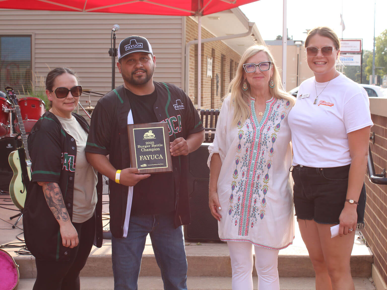 Fayuca2025 Fayuca's owners standing with community members accepting their plaque for best burger 2025.