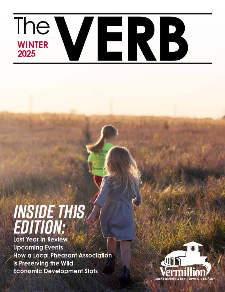 The cover of the 2025 Winter Verb issue. Two children run in a pasture at sunset.