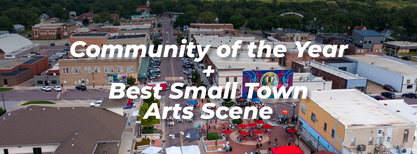 Community of the Year + Best Small Town Arts Scene text overlay on a drone photo of downtown Vermillion.