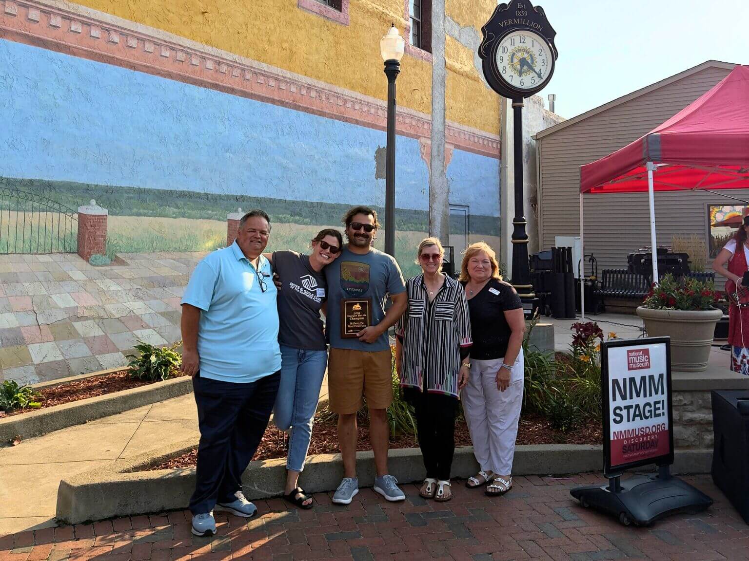 Mulberry Wood-Fired Pizza Owners with Maloney Real Estate with the 2026 winner plaque.