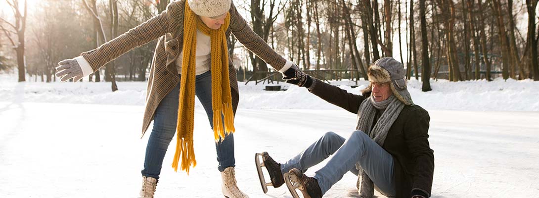 couple in sunny winter nature ice skating.