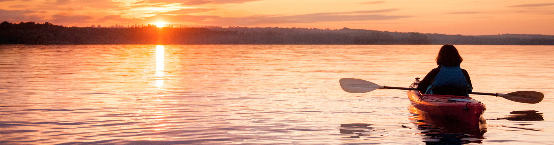kayaking on lake at sunset