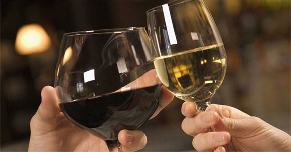 man and woman toasting wine glasses