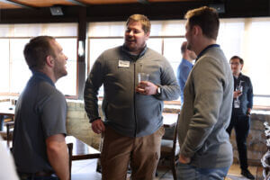 Three YPN members network at the March 2025 Off the Clock social.
