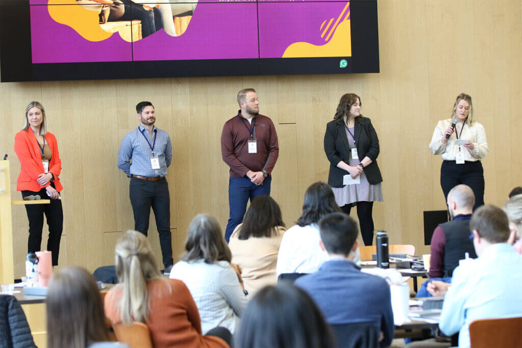 Five Leadership FMWF participants on stage during their Community Change Initiative presentation.