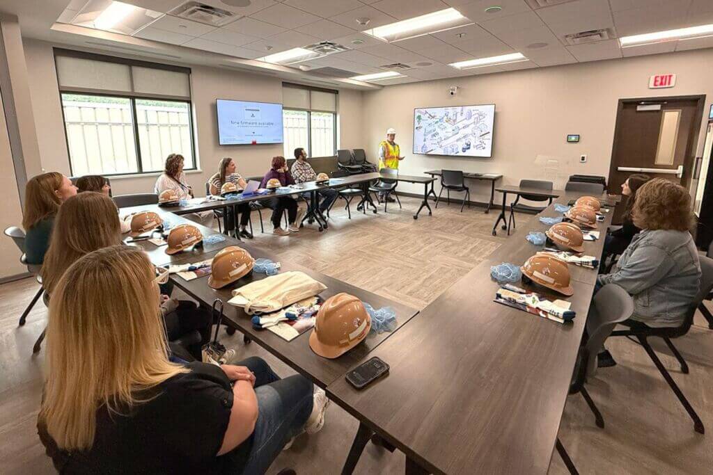 Education professionals sit around a table during the 2025 EDventures program to discuss bias in education.