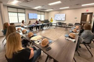 Education professionals sit around a table during the 2025 EDventures program to discuss bias in education.