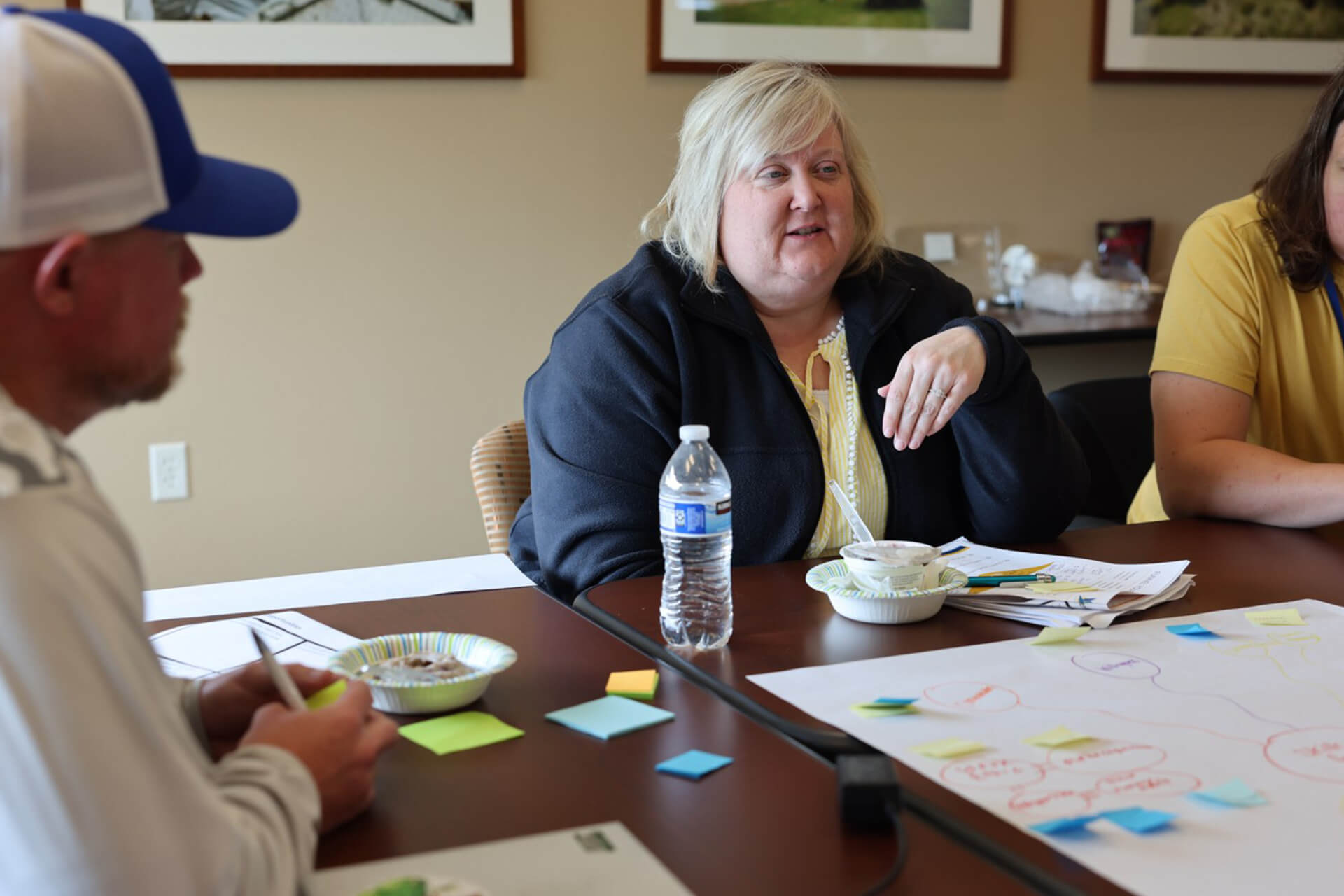 Education professionals sit around a table during the 2025 EDventures program to discuss bias in education.