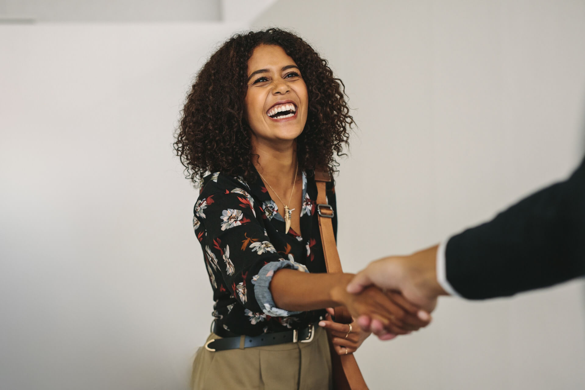 7-28_Blog-CC Woman shaking hands with an employer thanks to the Community Concierge program.