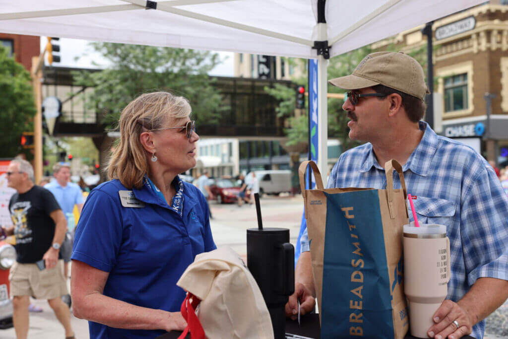 Concierge Strategist, Donna Heck, connects with local community member during a Community Concierge IceBreaker event in Downtown Fargo.