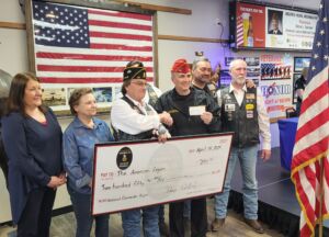 Fargo Moorhead Legion Riders present a check to the American Legion National Commander.