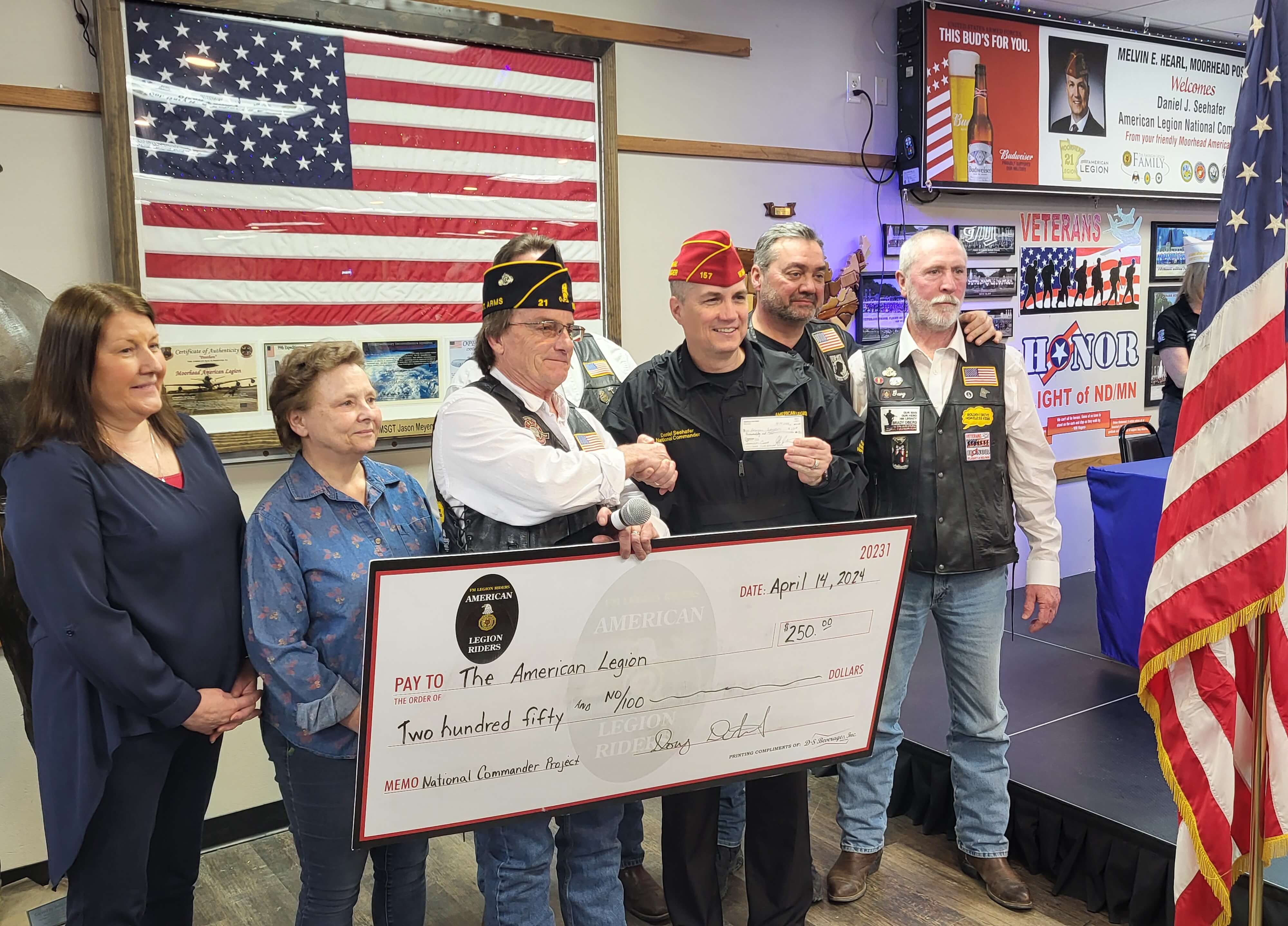 Fargo Moorhead Legion Riders present a check to the American Legion National Commander.