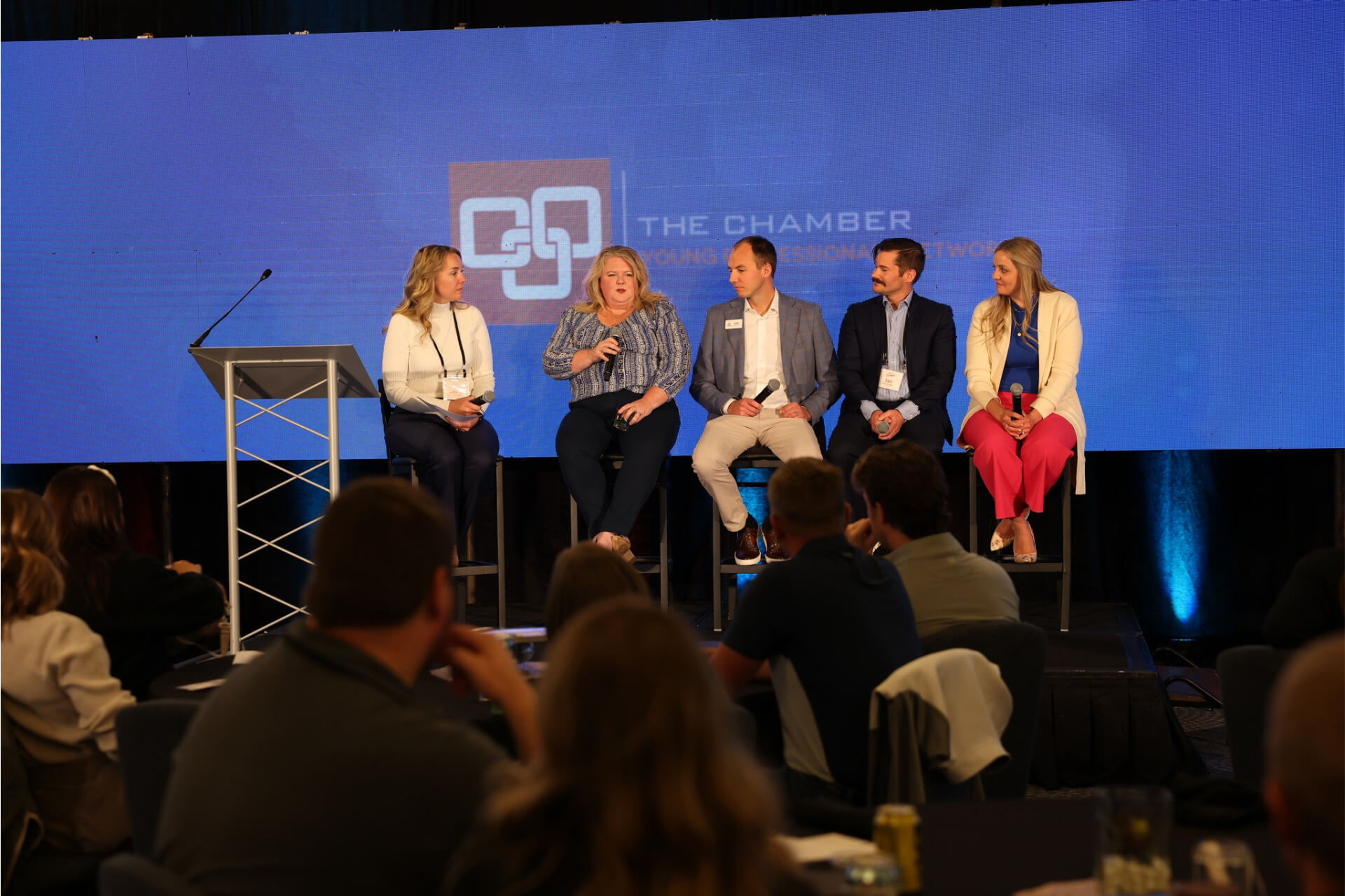 Five panelists sit on stage presenting during the 2024 YP Summit.