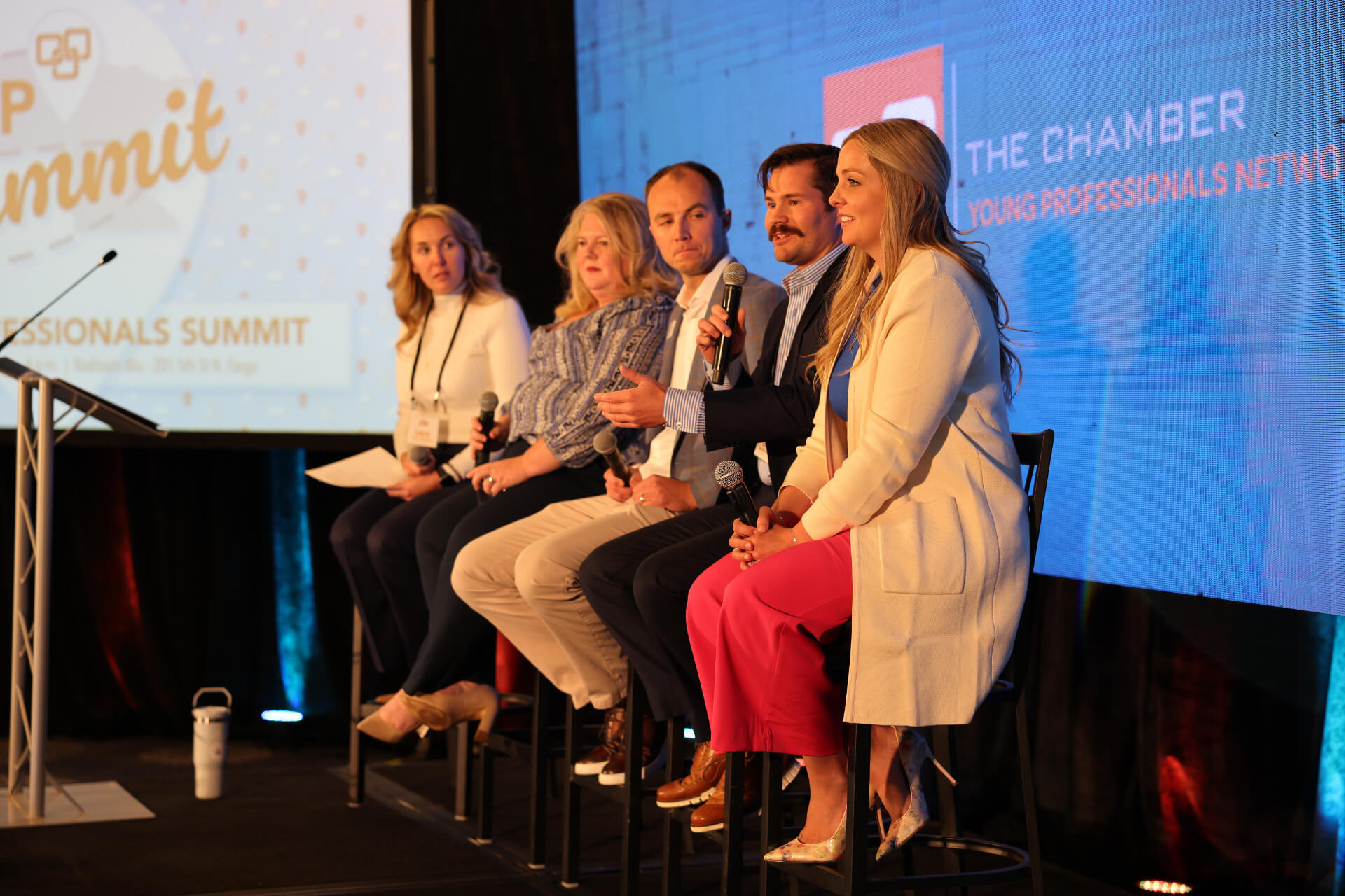 8-29_BlogHeader-YP Summit Four panelists sit on stage on the 2024 Young Professionals (YP) Summit, discussing topics like growth, imposter syndrome, and more.