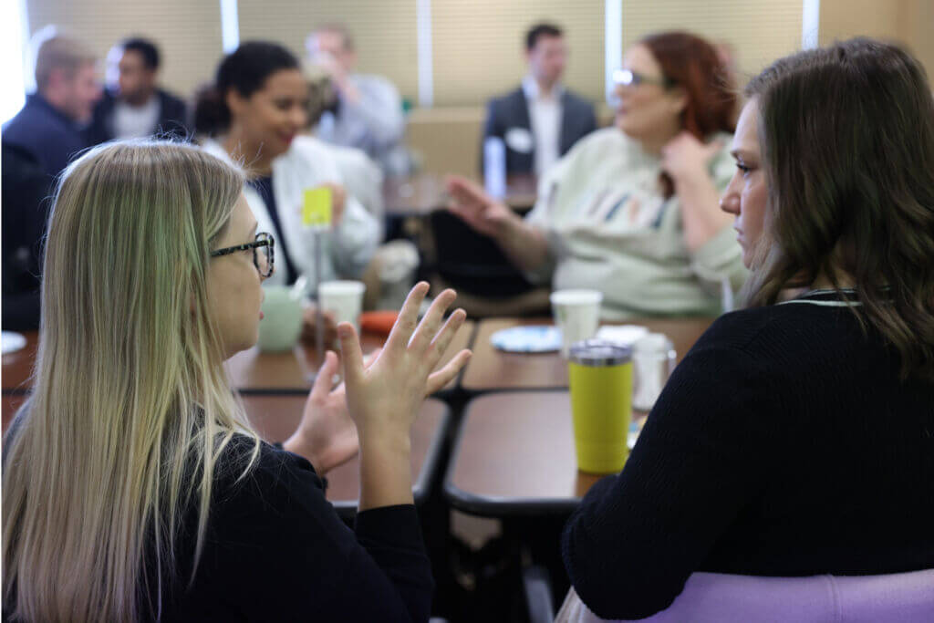 Two young professional women connect at Young Professionals Network Breakfast Club.