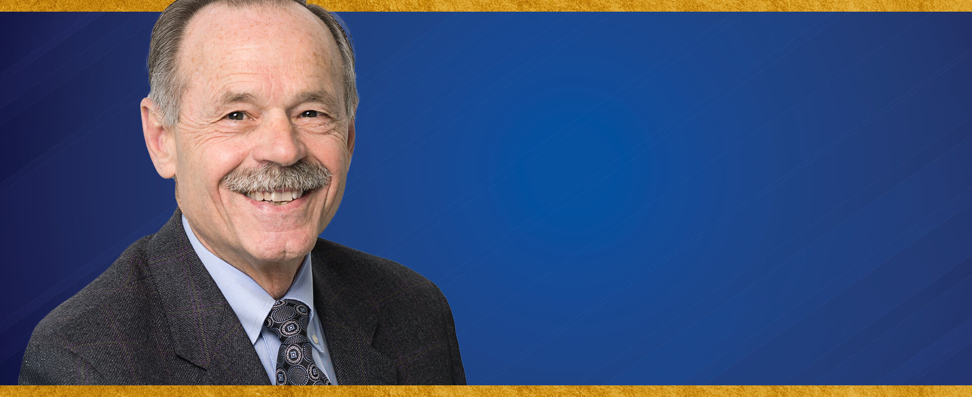 2025 Legacy Leader, Jeffry J. Volk'headshot on a blue background for the Annual Celebration