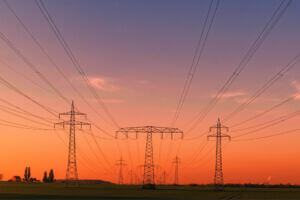 Sunset over power lines and open fields, highlighting the energy trends driving innovation across the Midwest.