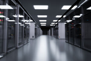 A row of illuminated servers in a modern data center, representing the connection between AI and energy infrastructure.