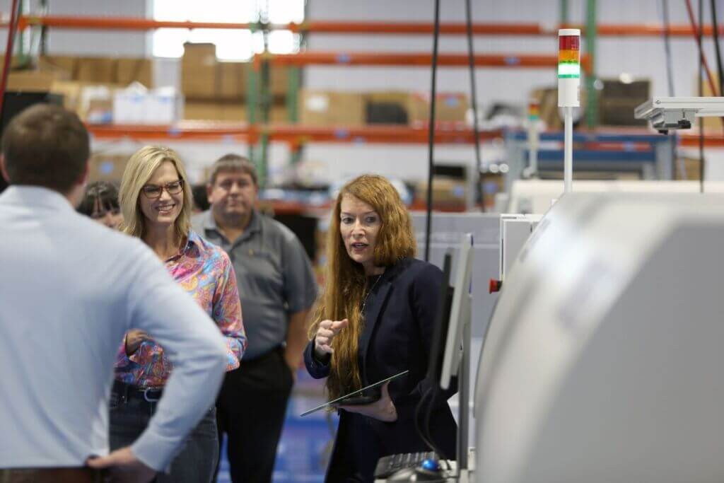 Terri Zimmerman speaks with guests during a Packet Digital tour, offering a behind-the-scenes look at the company’s high-performance power solutions.