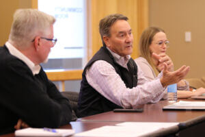 Former Congressman Rick Berg (middle) engages in conversation with business leaders during a regional meeting focused on civic leadership and public service.