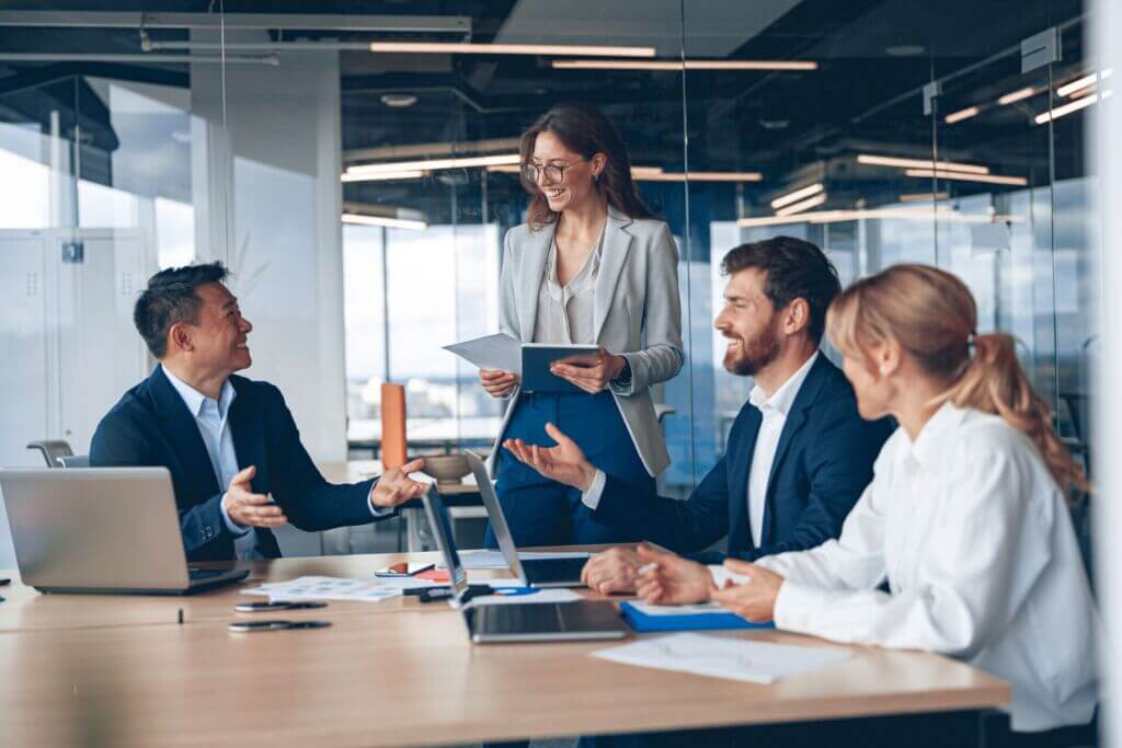 A group of individuals around a corporate table discussing practical business banking innovation