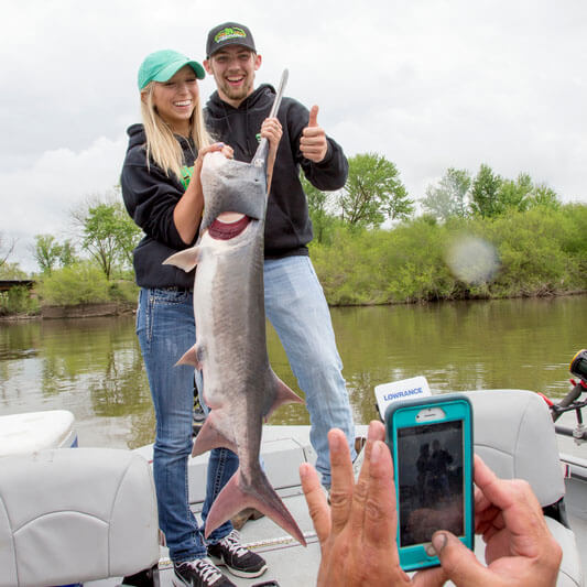 couple holding huge fish