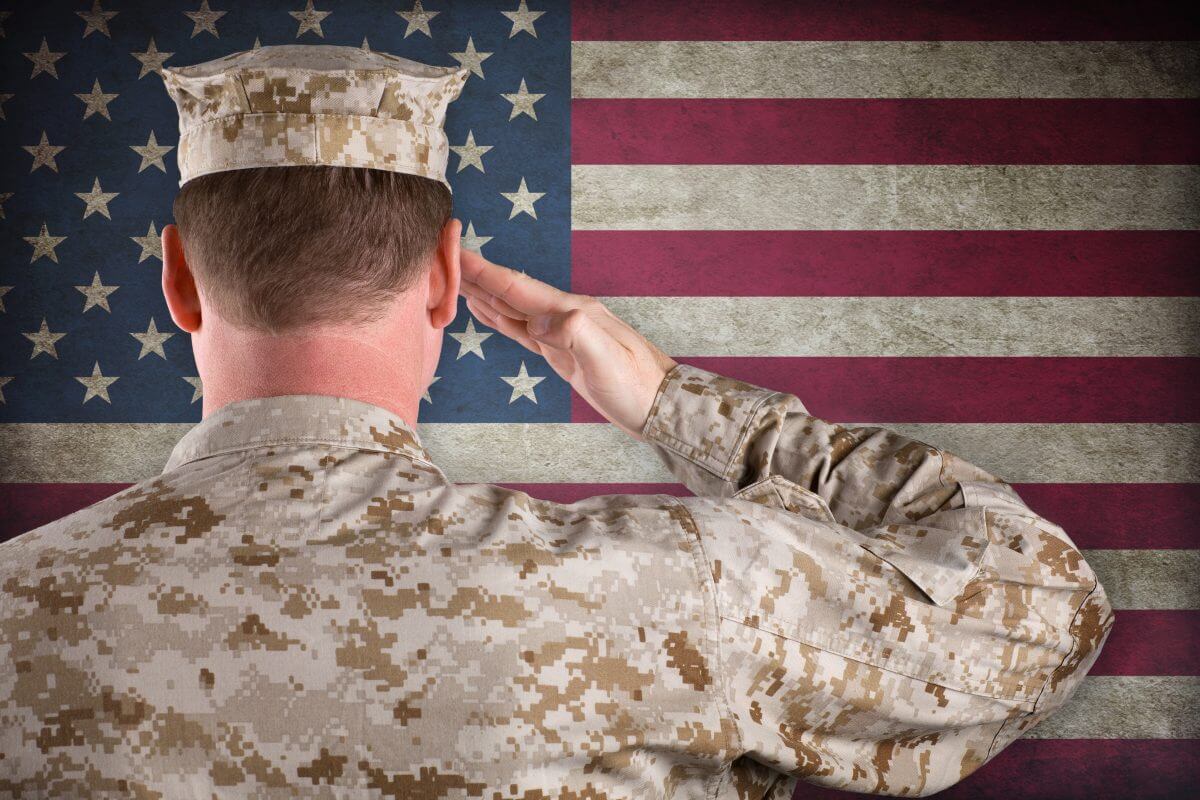 veteran in front of te flag