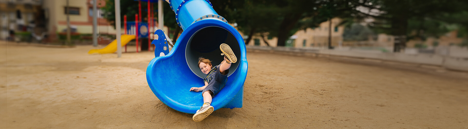 Boy coming out of slide opening