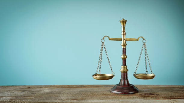 Scales of justice on the wooden table