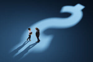 A business people standing on the US/Australian dollar sign on the floor made with light and shadow