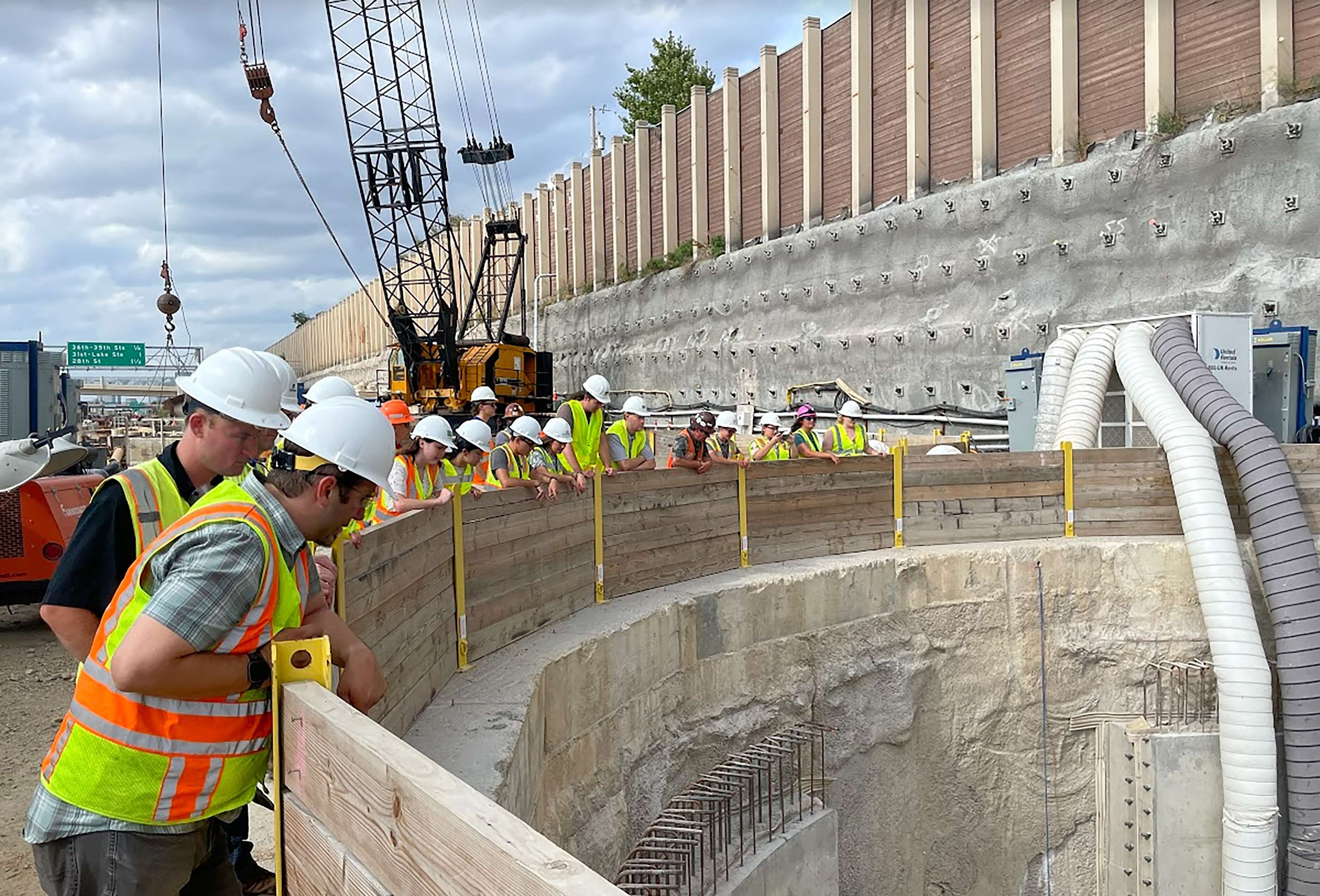 Engineers look down into stormwater basin