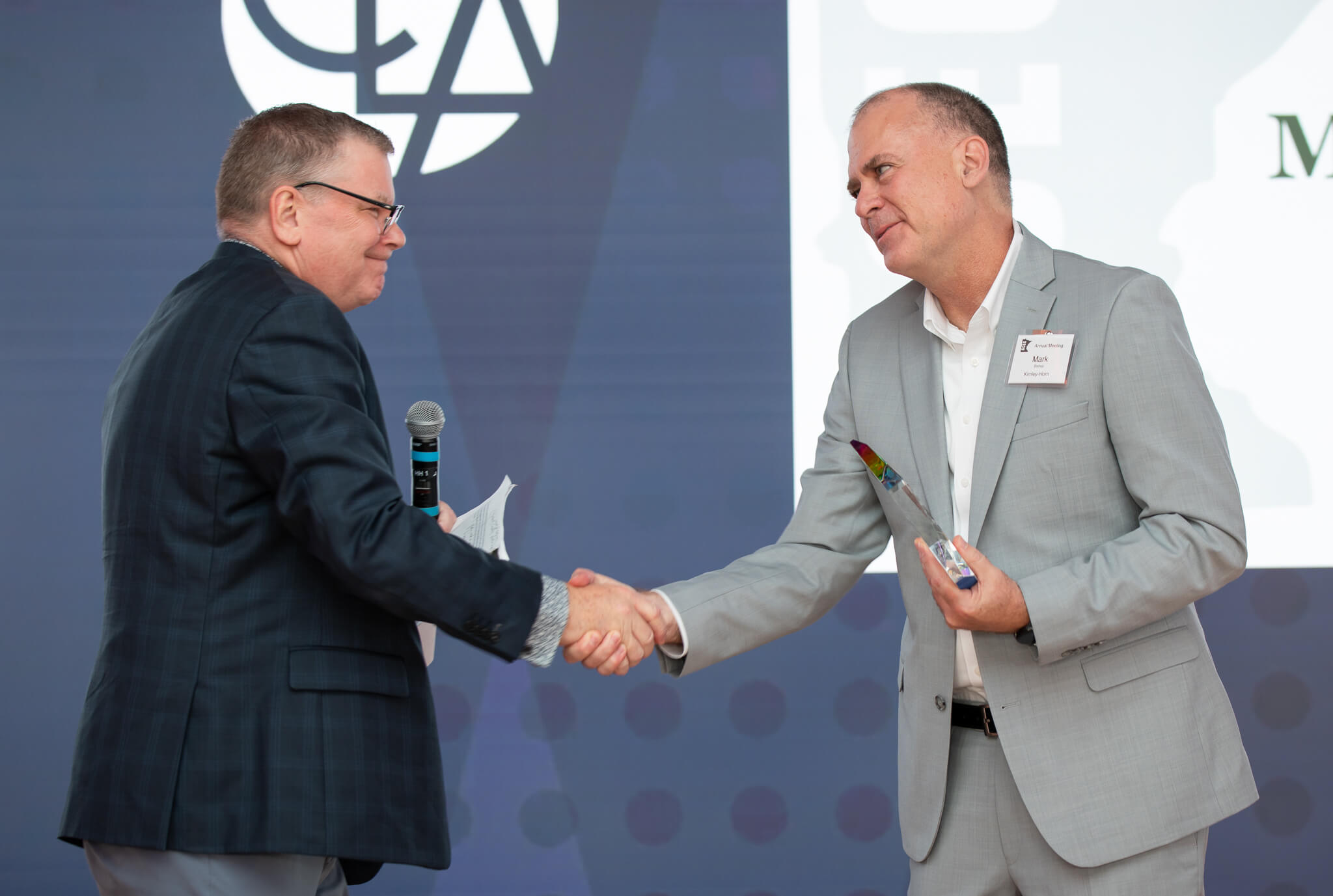 Bill Forsmark presenting the 2026 Chair's Award to Mark Bishop on stage