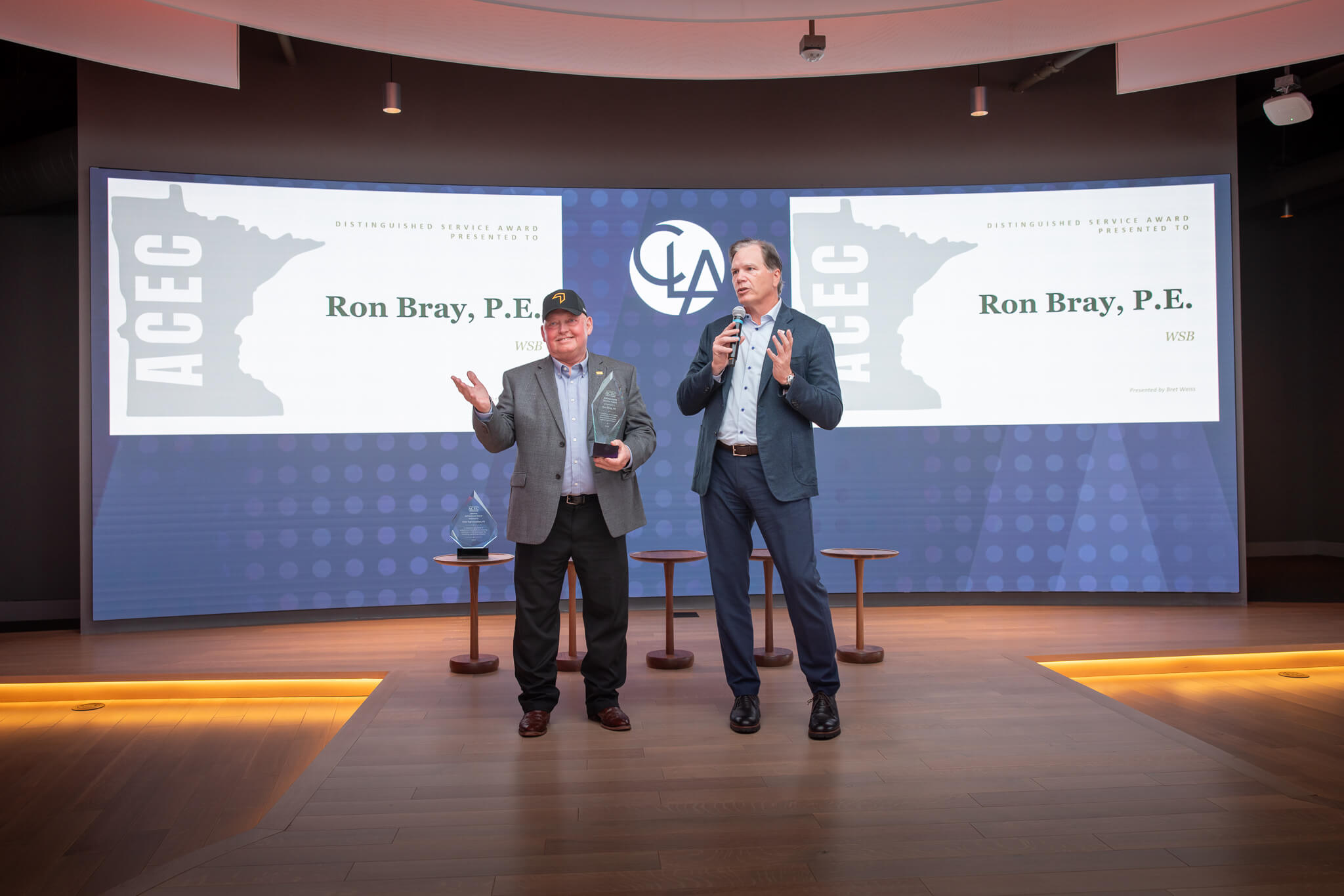 Ron Bray and Bret Weiss on stage during the Distinguished Service Award presentation