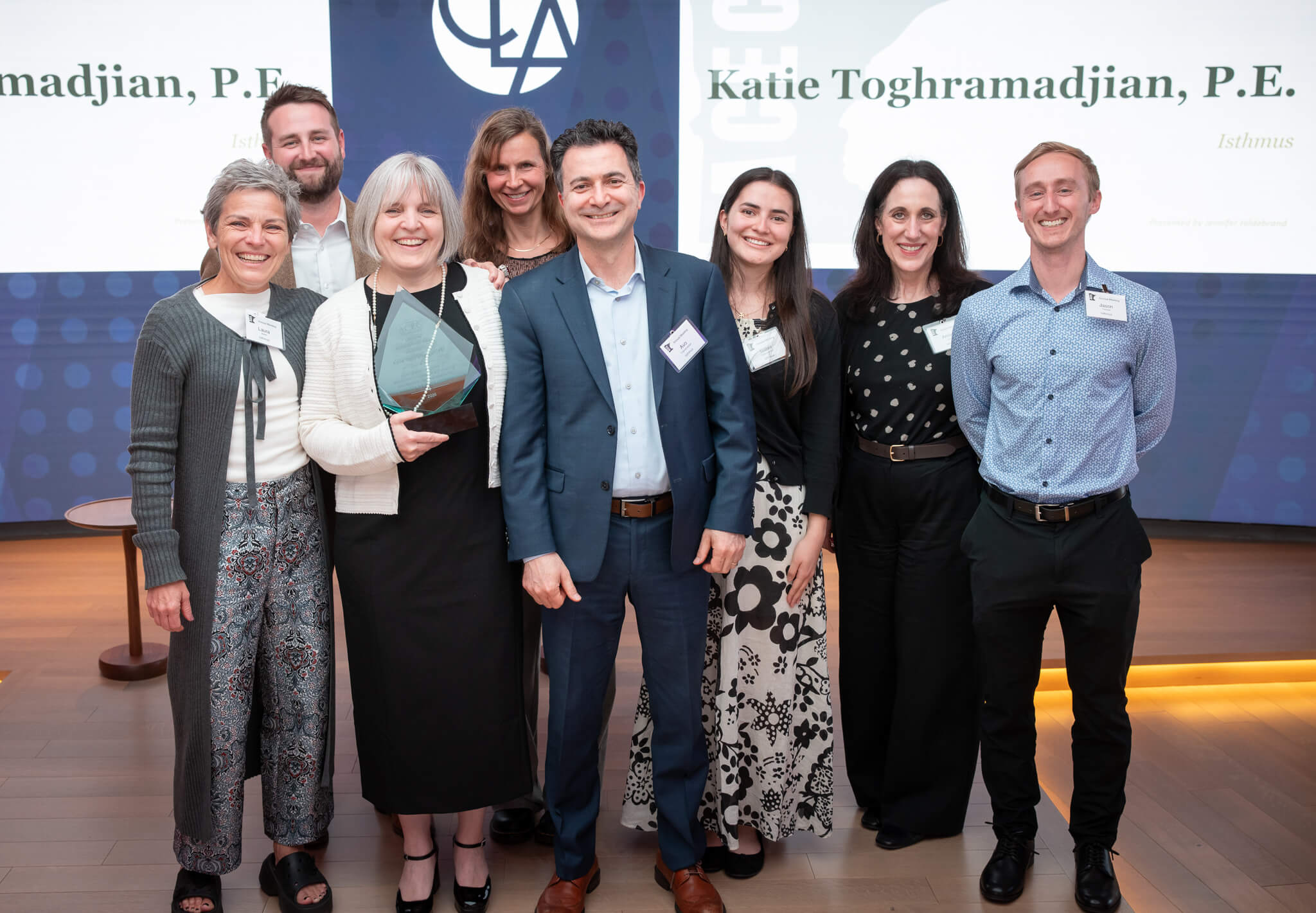 Katie Toghramadjian with her family and Isthmus Engineering staff