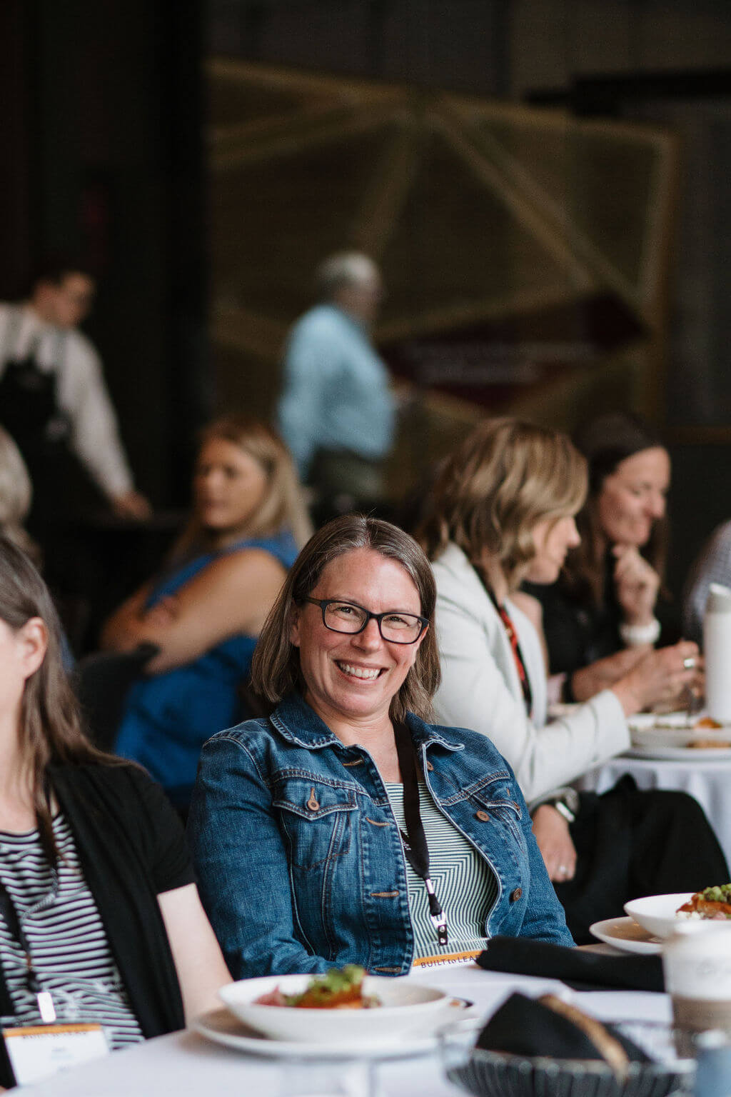 An attendee smiles during the lunch program